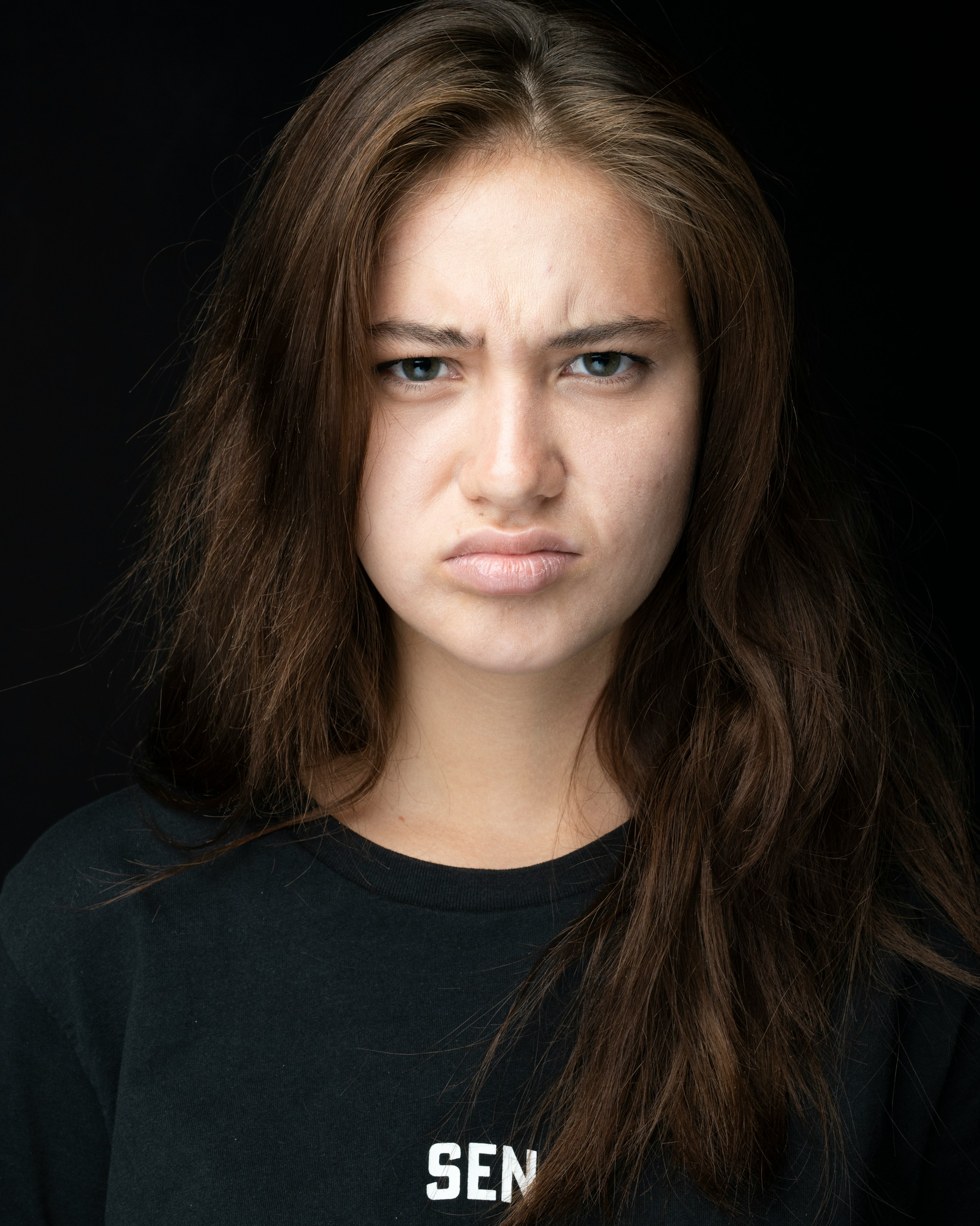 A frowning woman wearing ‍black |⁣ Source: Unsplash