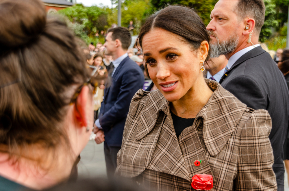 Wellington, New Zealand - October 28, 2018: The Duchess of Sussex chats with a member of the crowd at the Wellington War Memorial in New Zealand.
