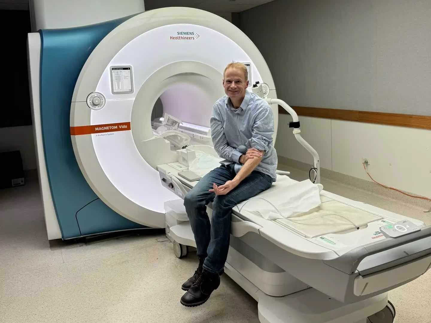 Richard Scolyer sitting near MRI machine 