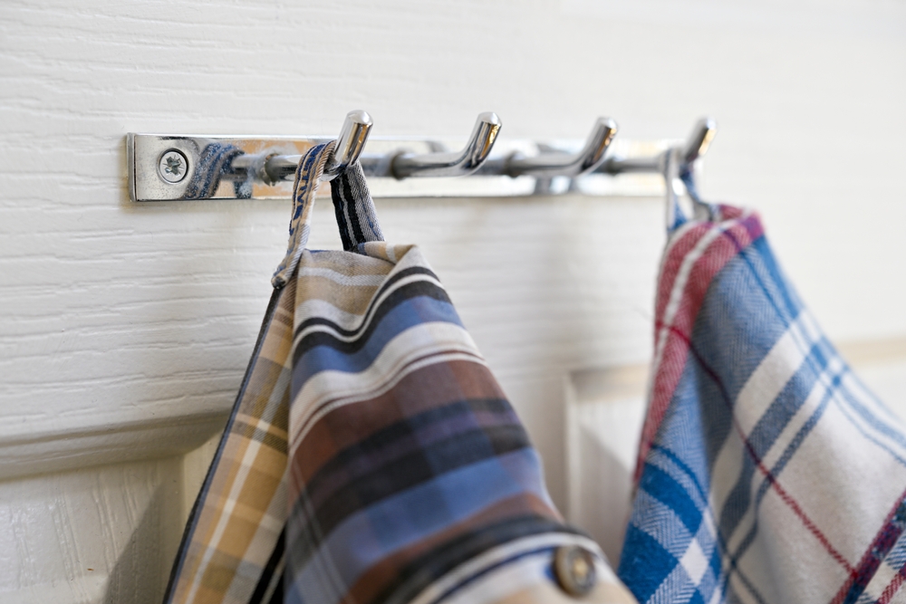 Shirts on hangers hanged from locker loop on the back side of shirt
