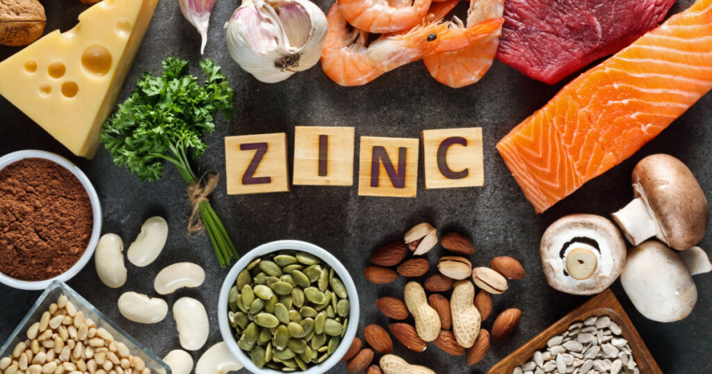 Foods High in Zinc as salmon, seafood-shrimps, beef, yellow cheese, parsley leaves, mushrooms, cocoa, pumpkin seeds, garlic, bean, almonds, pine nut. Top view