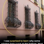 Why are some window bars curved at the bottom
