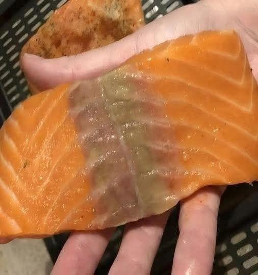 I bought salmon a week ago and wanted to make it for dinner today. When I took it out of the refrigerator, it had a yellow stain on it. What is it?