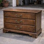 Woman measures a bulky old dresser and makes one bold cut. The result looks store-bought